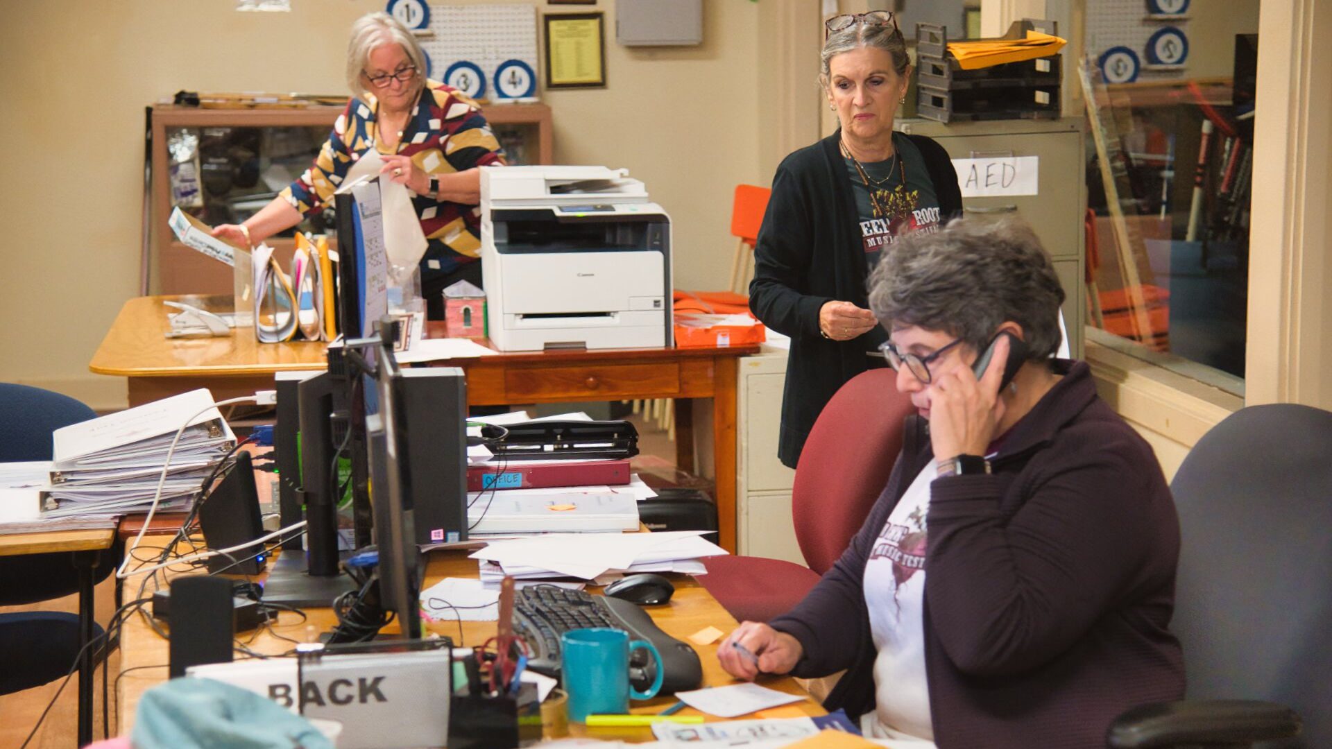 People working in Deep Roots Music Festival Office